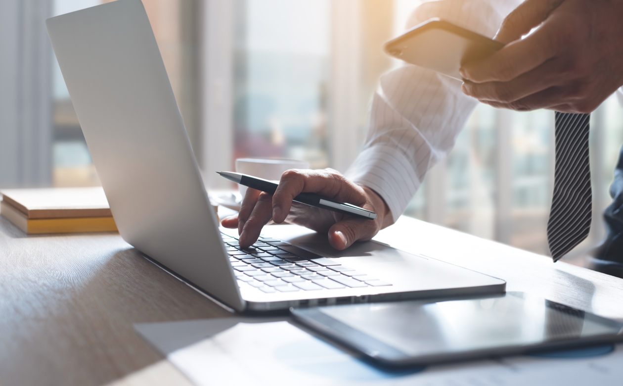 Mand holder computer og telefon