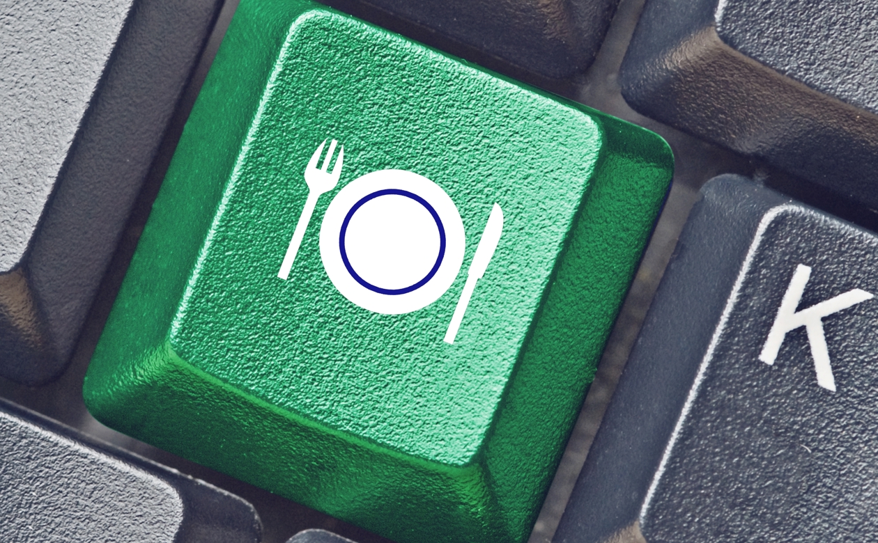 Grøn tastaturknap med tallerken og bestik på