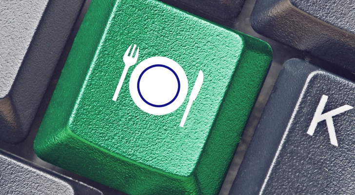 Grøn tastaturknap med tallerken og bestik på