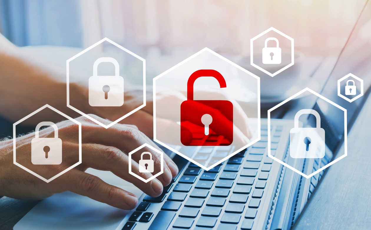 Hænder på tastatur med ikoner af it-sikkerhed i form af hængelåse over