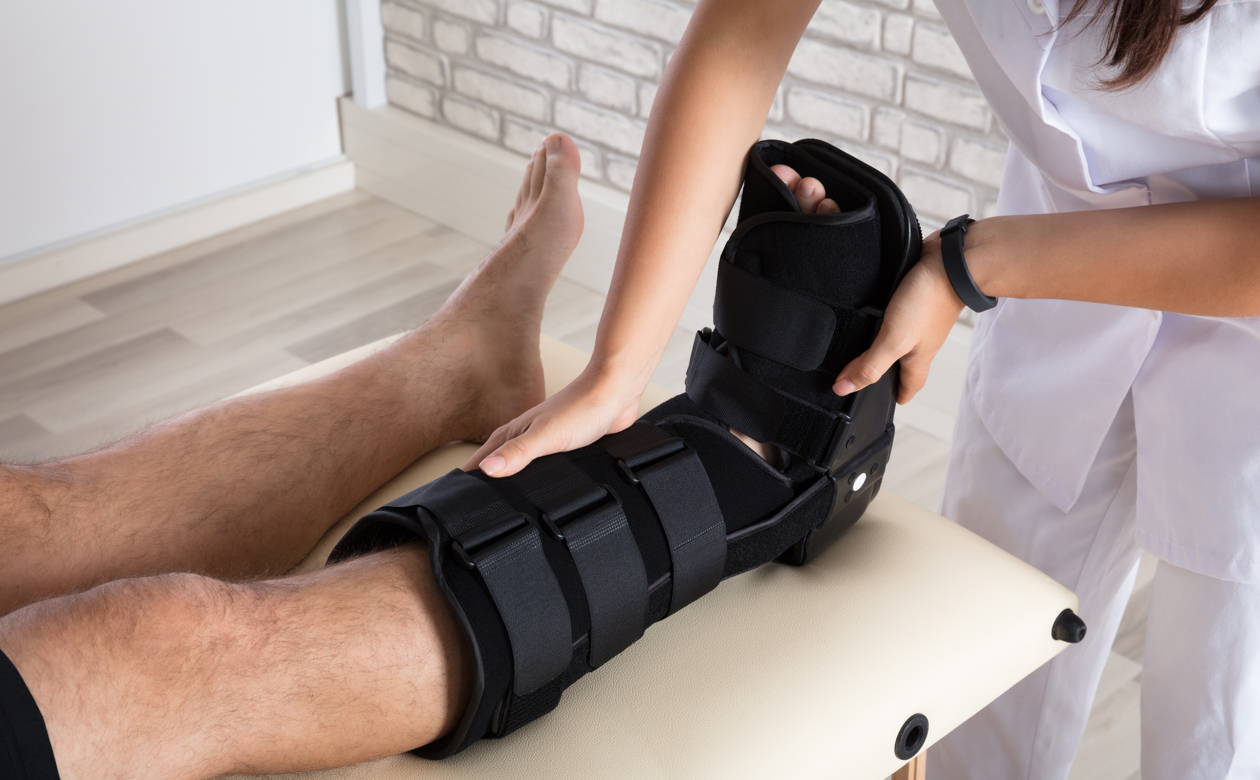 Læge tjekker fod med skinne